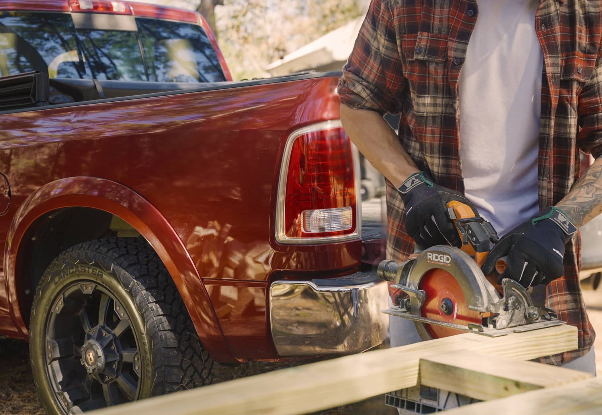 lancaster-tire-pickup-truck-construction-project Red pickup truck equipped with Lancaster all-terrain tires parked beside a construction project, highlighting durability, traction, and everyday performance.
